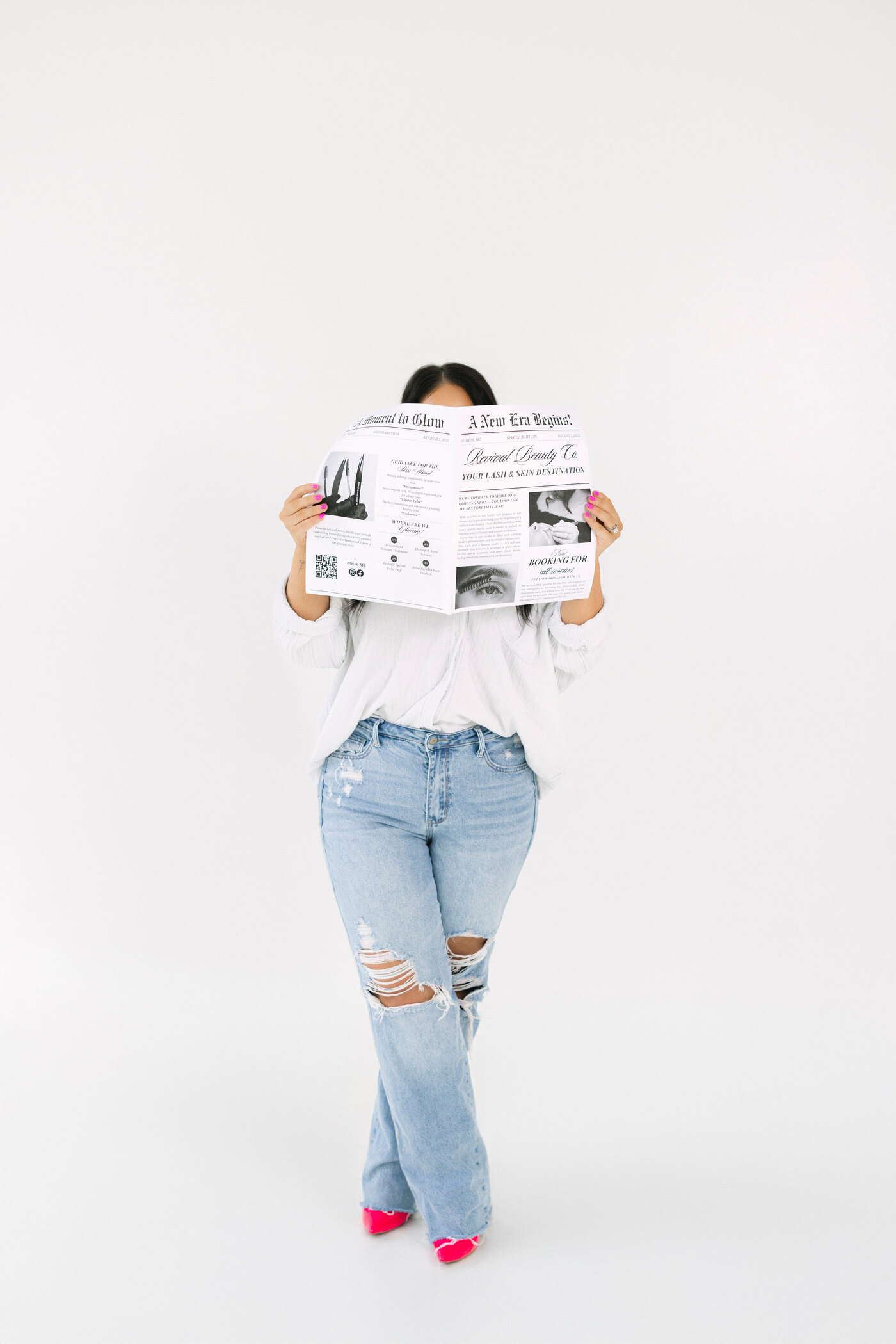 McKinzie holding her paper: A New Era Begins, Revival Beauty Co.
